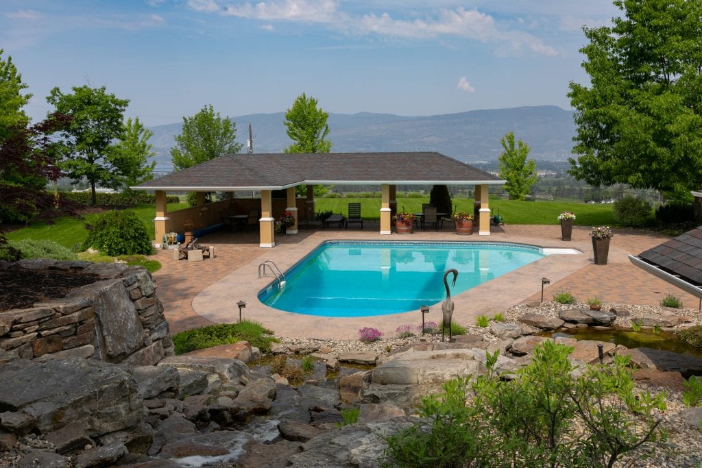 Outdoor living - pool and lounge area in greater Kelowna home.