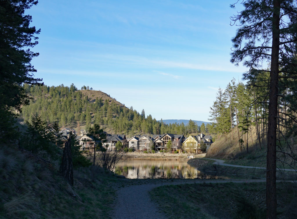 Kelowna's Wilden community in Glenmore, with a row of houses hidden along a path to a pond